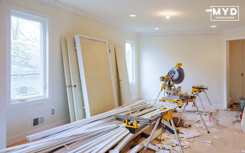 Interior renovation site with building materials and tools.