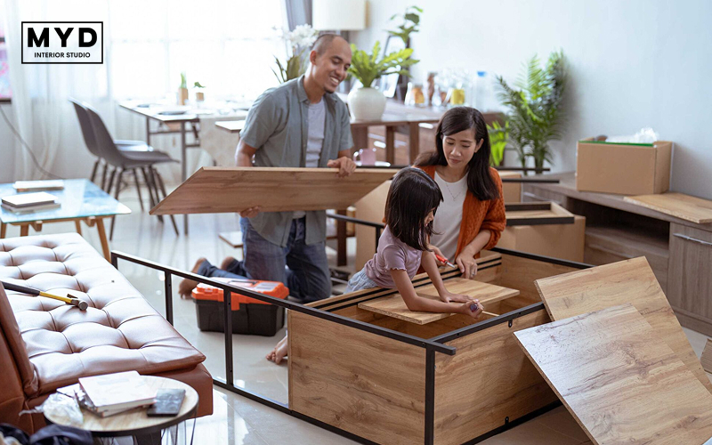 Family assembling furniture together at home showing practical home renovation ideas